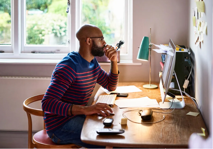 A Thinker working at his computer