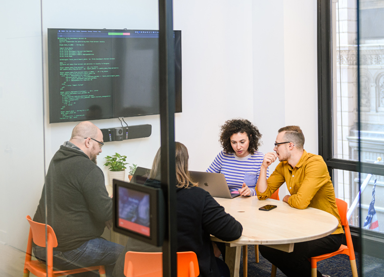 developers coding website in meeting room