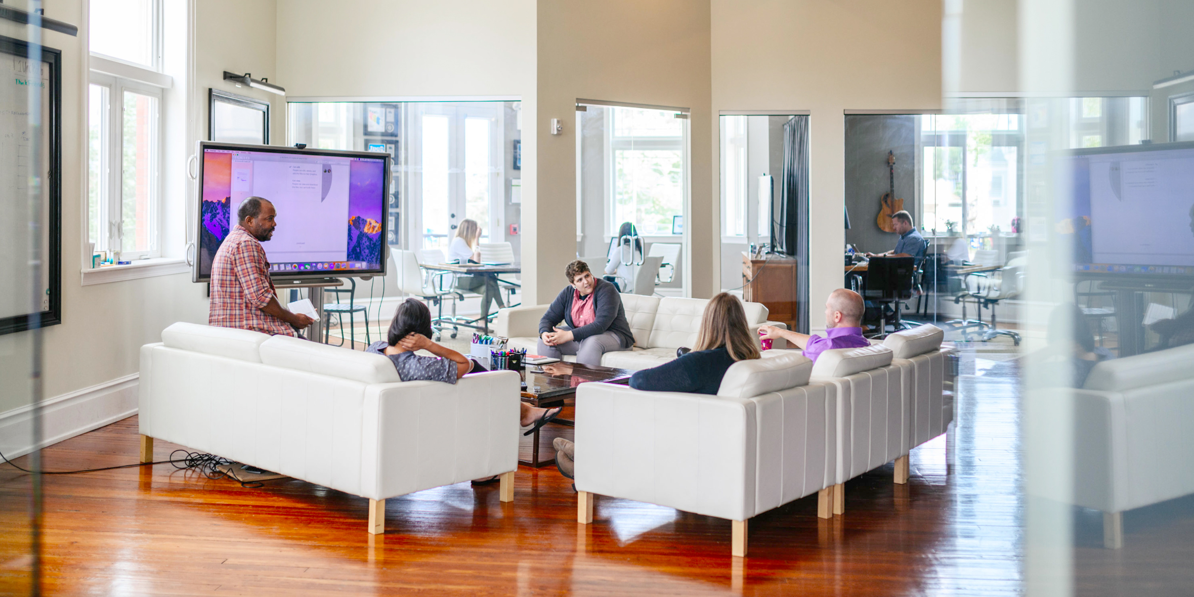 Photo of employees in modern office lounge