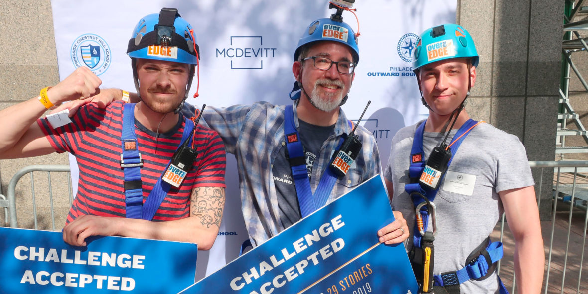 Photo of three men wearing repelling gear