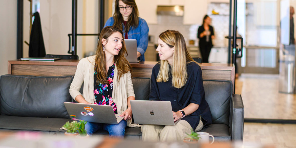 Photo of two women talking in an office