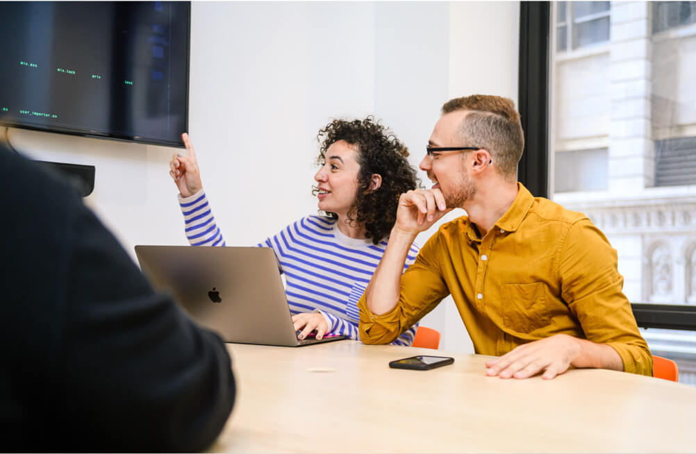 Two people working in a conference room