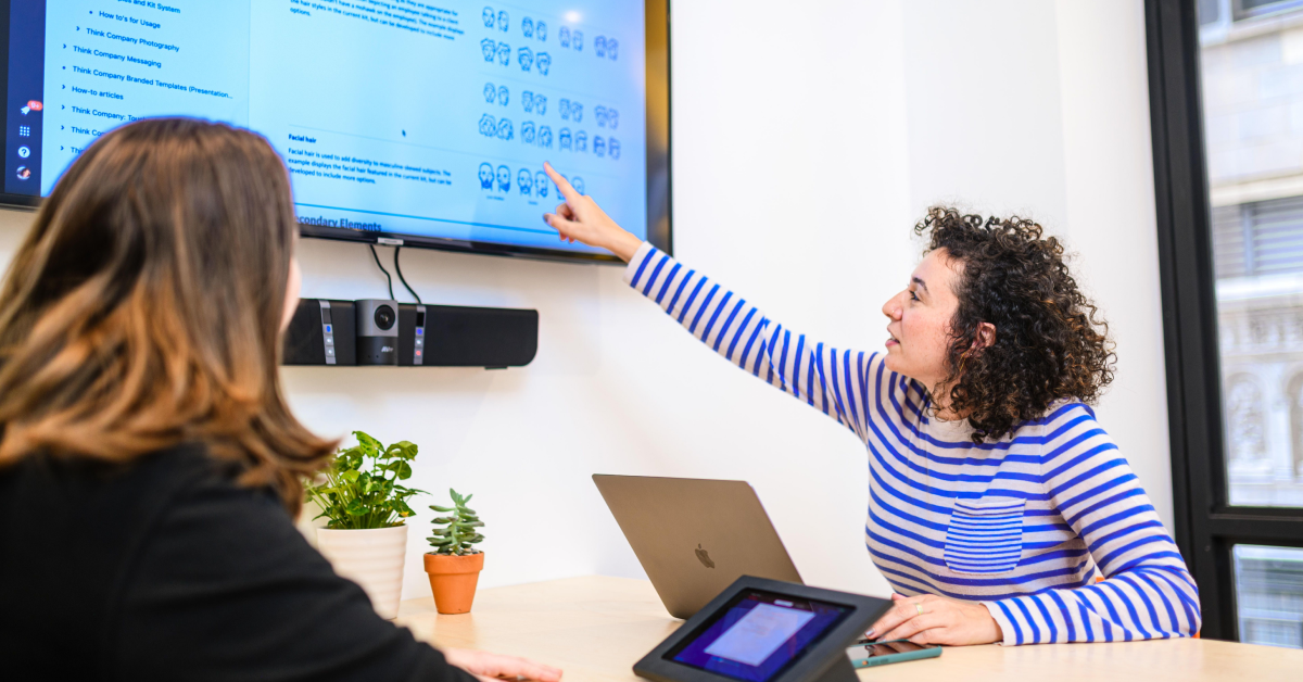 Two people working together in a conference room