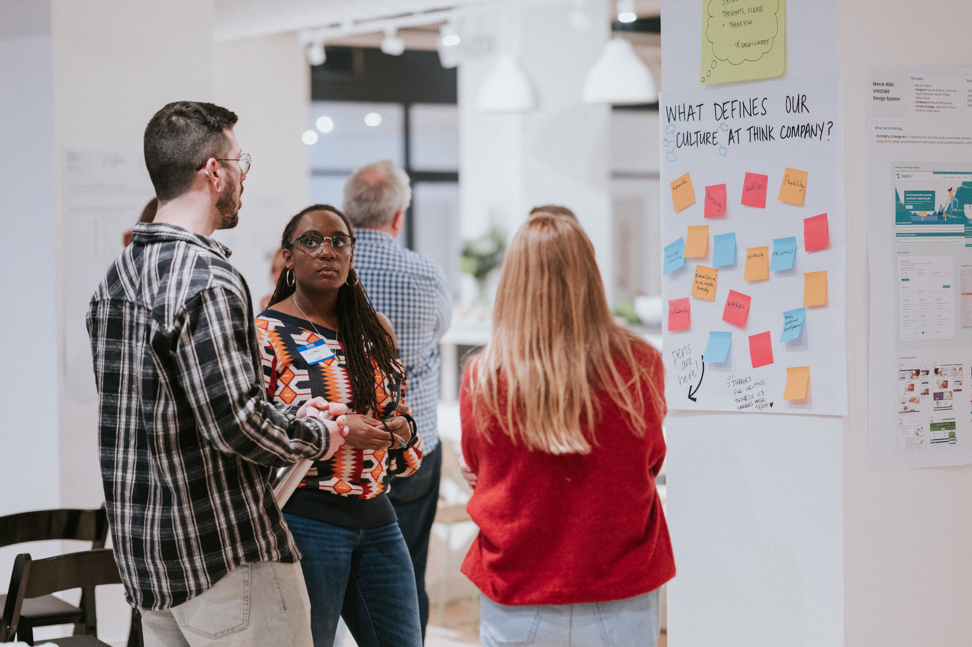 People talking and reviewing a poster