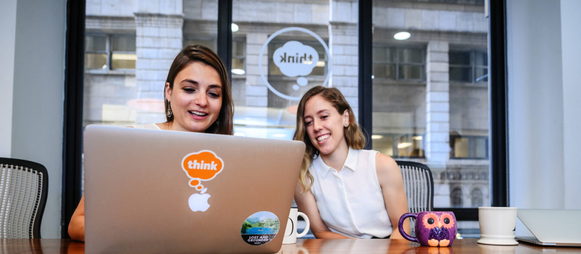 Two people collaborating together at a laptop