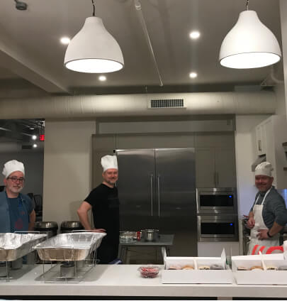 group of people wearing chef's hats in a kitchen