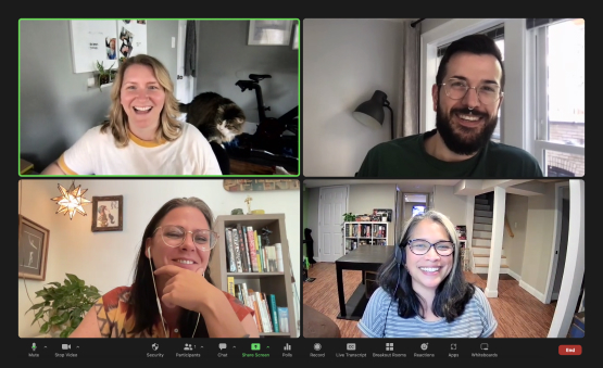 zoom meeting with four participants smiling