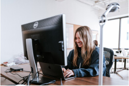 A person sitting at a computer typing