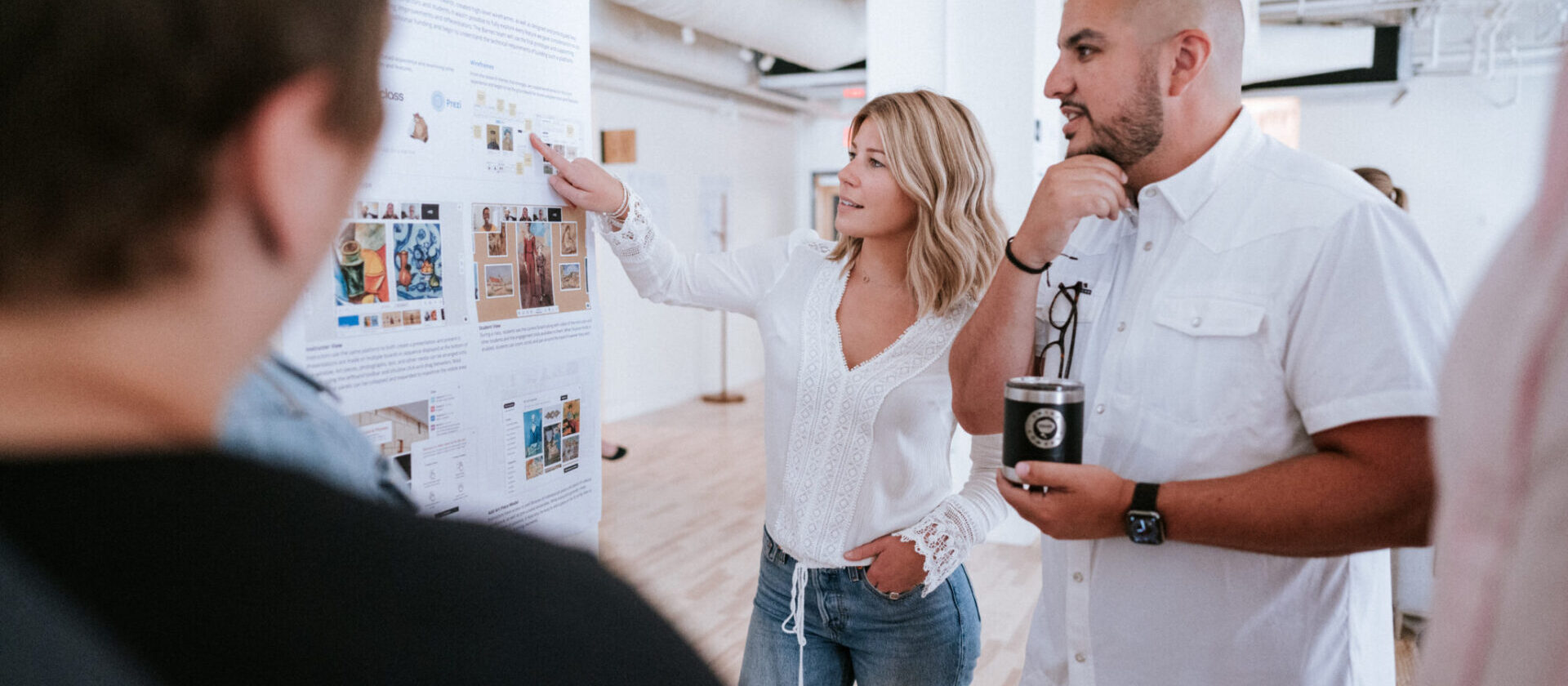 People collaborating on design and development planning while looking at some documentation taped to a wall