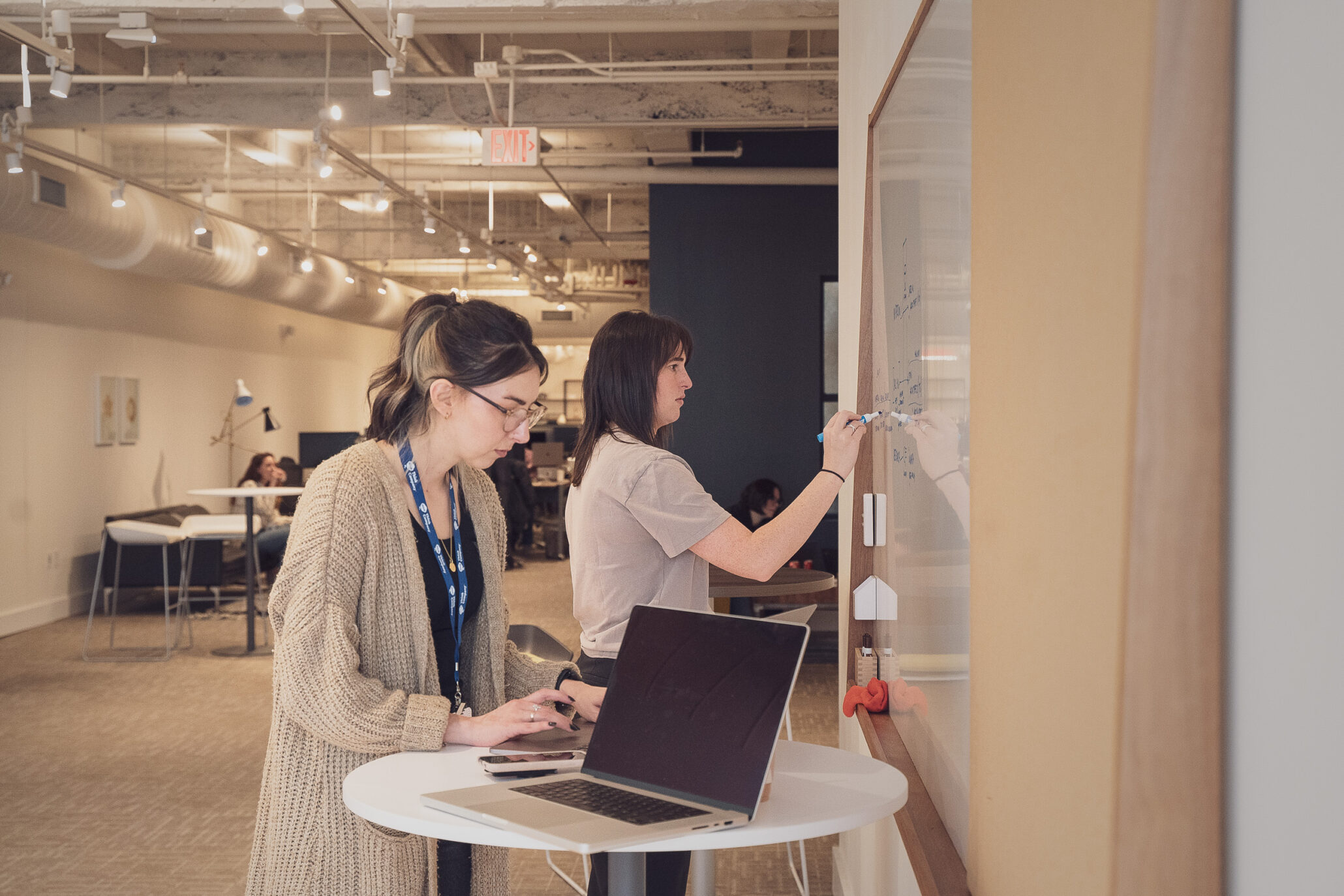 Telecom UX designers working at a whiteboard